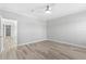 Light-filled bedroom with wood-look floors and a view to another room at 6924 Americana Ne Dr # 167, St Petersburg, FL 33702