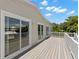 Exterior view of a deck featuring white railings and sliding glass doors at 6924 Americana Ne Dr # 167, St Petersburg, FL 33702