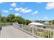 Spacious deck with white railing overlooking a canal, trees and surrounding neighborhood at 6924 Americana Ne Dr # 167, St Petersburg, FL 33702