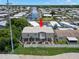 Charming elevated coastal home with a well-maintained yard and a white picket fence at 6924 Americana Ne Dr # 167, St Petersburg, FL 33702