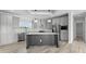 Bright eat-in kitchen with gray cabinets, an island, stainless appliances, and hard surface countertops at 6924 Americana Ne Dr # 167, St Petersburg, FL 33702