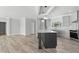 Modern eat-in kitchen with an island, gray cabinets, modern appliances, and hard surface countertops at 6924 Americana Ne Dr # 167, St Petersburg, FL 33702
