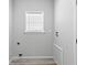 Compact laundry room with a window and hookups for a washer and dryer at 6924 Americana Ne Dr # 167, St Petersburg, FL 33702