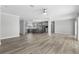Spacious living room showcasing hardwood floors, gray kitchen and modern appliances at 6924 Americana Ne Dr # 167, St Petersburg, FL 33702