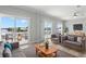 Cozy living room with water view balconies features modern furniture and a ceiling fan at 6924 Americana Ne Dr # 167, St Petersburg, FL 33702