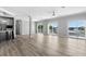 Spacious living room features modern gray color scheme, water view balconies, and wood-look flooring at 6924 Americana Ne Dr # 167, St Petersburg, FL 33702
