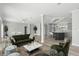Open-concept living room with modern decor, hardwood floors and an adjoined gray kitchen at 6924 Americana Ne Dr # 167, St Petersburg, FL 33702