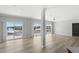Open floor plan features light gray walls, modern flooring, and sliding glass doors with balcony access at 6924 Americana Ne Dr # 167, St Petersburg, FL 33702