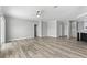 Spacious living room with gray kitchen, hardwood floors, ceiling fan and white trim at 6924 Americana Ne Dr # 167, St Petersburg, FL 33702
