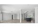 Spacious living room with hardwood floors, gray kitchen and modern lighting at 6924 Americana Ne Dr # 167, St Petersburg, FL 33702