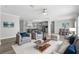 Open living space featuring hardwood floors, stylish furniture, and a modern gray kitchen at 6924 Americana Ne Dr # 167, St Petersburg, FL 33702