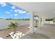 Landscaped undercarriage with white rock, small palm trees, and perimeter fencing at 6924 Americana Ne Dr # 167, St Petersburg, FL 33702