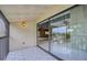 Tile patio with sliding glass doors, offering a view of the lush landscaping at 700 Starkey Rd # 1145, Largo, FL 33771