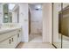 Neutral bathroom with white cabinets, a large mirror, and a glass enclosed shower at 700 Starkey Rd # 1145, Largo, FL 33771