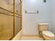 Bathroom featuring a shower with glass doors and a toilet adjacent to a clear towel rack at 700 Starkey Rd # 1145, Largo, FL 33771