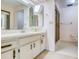 Bathroom featuring white countertops, a large mirror, and an enclosed shower at 700 Starkey Rd # 1145, Largo, FL 33771