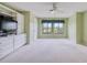 Bright bedroom featuring a ceiling fan, built in shelves, and a large window with a picturesque view at 700 Starkey Rd # 1145, Largo, FL 33771