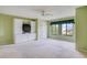 Large bedroom with carpet floors, custom built-ins, and a large window for natural light at 700 Starkey Rd # 1145, Largo, FL 33771
