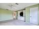 Green bedroom showcasing a ceiling fan, large closet, and built in media center with shelves at 700 Starkey Rd # 1145, Largo, FL 33771