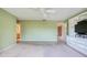 Bright green bedroom with carpet and built in media center next to a bathroom entrance at 700 Starkey Rd # 1145, Largo, FL 33771