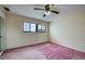 Bedroom featuring a ceiling fan, light paint and a window to capture exterior views at 700 Starkey Rd # 1145, Largo, FL 33771