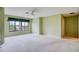 Spacious bedroom featuring a ceiling fan, neutral carpet, and green walls at 700 Starkey Rd # 1145, Largo, FL 33771