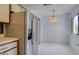 Bright dining area with window, accent lighting, closet with mirror doors, and stainless refrigerator at 700 Starkey Rd # 1145, Largo, FL 33771