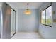 Dining area features a window, tile flooring, accent lighting, and a stainless steel refrigerator at 700 Starkey Rd # 1145, Largo, FL 33771