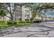 View of the condominium exterior, showcasing the well-maintained landscaping and covered parking area at 700 Starkey Rd # 1145, Largo, FL 33771