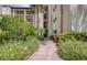 Lush landscaping and blooming flowers surround the exterior walkway to the condominium at 700 Starkey Rd # 1145, Largo, FL 33771