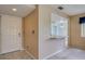 Foyer featuring tile flooring, front door, bar countertop opening to dining area, and neutral paint at 700 Starkey Rd # 1145, Largo, FL 33771