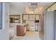 Kitchen featuring white cabinetry, stainless steel refrigerator, and an open concept design at 700 Starkey Rd # 1145, Largo, FL 33771