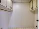 Bright laundry room with white cabinets and a convenient hanging rod for your garments at 700 Starkey Rd # 1145, Largo, FL 33771
