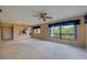 Cozy living room with large windows, a ceiling fan, and an open layout to the kitchen at 700 Starkey Rd # 1145, Largo, FL 33771