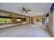 Open concept living room with carpet, a mirrored wall, and an opening to the kitchen and bar area at 700 Starkey Rd # 1145, Largo, FL 33771