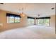 Expansive living room featuring plush carpeting, bright windows with beautiful curtains, and a ceiling fan at 700 Starkey Rd # 1145, Largo, FL 33771
