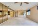 Spacious living room featuring a mirrored wall, carpet flooring, and access to the kitchen and entry at 700 Starkey Rd # 1145, Largo, FL 33771