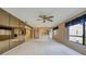 Carpeted living room with sliding glass doors, mirrored walls, and access to the kitchen and entry at 700 Starkey Rd # 1145, Largo, FL 33771