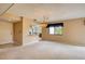 Bright living room featuring neutral carpeting, a chandelier, and an open layout to the kitchen at 700 Starkey Rd # 1145, Largo, FL 33771