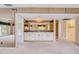 Carpeted living room with a built-in wet bar, mirrored wall, and views of the outdoor space at 700 Starkey Rd # 1145, Largo, FL 33771