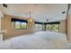 Spacious living room with neutral carpeting, abundant natural light, and access to the outdoors at 700 Starkey Rd # 1145, Largo, FL 33771