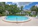 Sparkling community pool with clear blue water, surrounded by lush landscaping, for resident enjoyment at 700 Starkey Rd # 1145, Largo, FL 33771