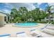Community pool with ample lounge chairs and lush landscaping creates a relaxing outdoor oasis for residents at 700 Starkey Rd # 1145, Largo, FL 33771