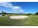 Well-maintained sand trap on a scenic golf course with a clear blue sky and scattered clouds at 700 Starkey Rd # 1145, Largo, FL 33771