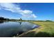 Beautiful view of a pond on the golf course, reflecting the blue sky and fluffy clouds at 700 Starkey Rd # 1145, Largo, FL 33771