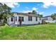 Quaint home featuring a red door and lush greenery in a serene setting at 812 W Orient St, Tampa, FL 33603