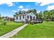 A single-story home with a walkway, front porch, and lush green lawn on a sunny day at 812 W Orient St, Tampa, FL 33603