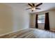 This bedroom features wood flooring, ceiling fan, and a bright window, creating a comfortable and inviting space at 8200 Westfield Dr, Port Richey, FL 34668