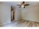 This bedroom features wood flooring, a ceiling fan, a closet, and neutral walls for a serene atmosphere at 8200 Westfield Dr, Port Richey, FL 34668