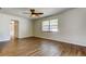 Bright bedroom featuring tile floors, crown molding, ceiling fan and a large window at 8200 Westfield Dr, Port Richey, FL 34668